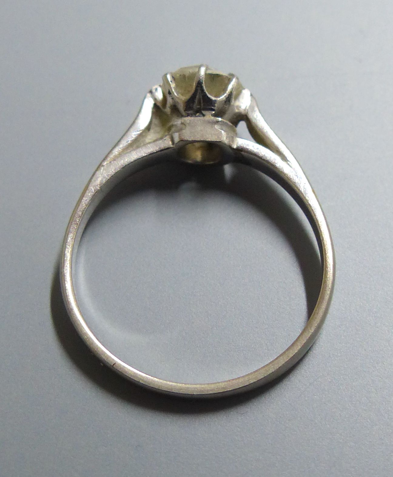 A white metal and old mine cut solitaire diamond ring, size M, gross 2.6 grams,